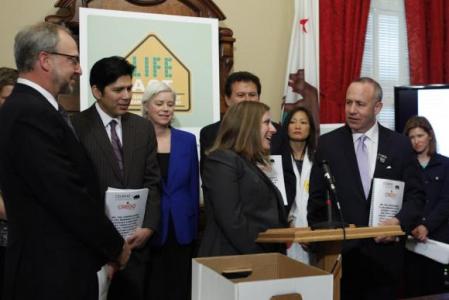 Julie Bernstein (center) at press conference with CA State Senator Darrell Steinberg (right).