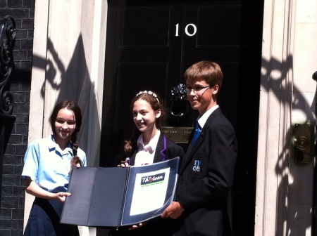 Orli Vogt-Vincent (center) with the 2nd and 3rd place winners of the contest in front of 10 Downing Street. (photo credit: courtesy of Orli Vogt-Vincent)